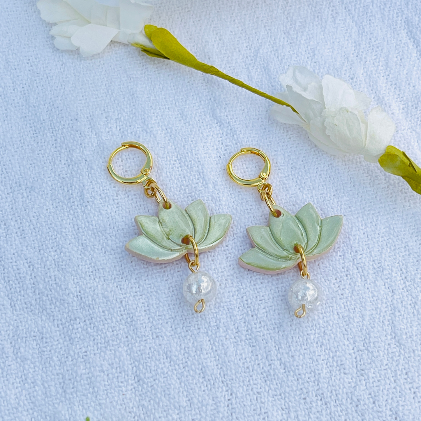 Green handcrafted Lotus Flower Earrings made from lightweight polymer clay, symbolizing purity and resilience. Unique, lead and nickel-free jewelry, perfect for sensitive ears.
