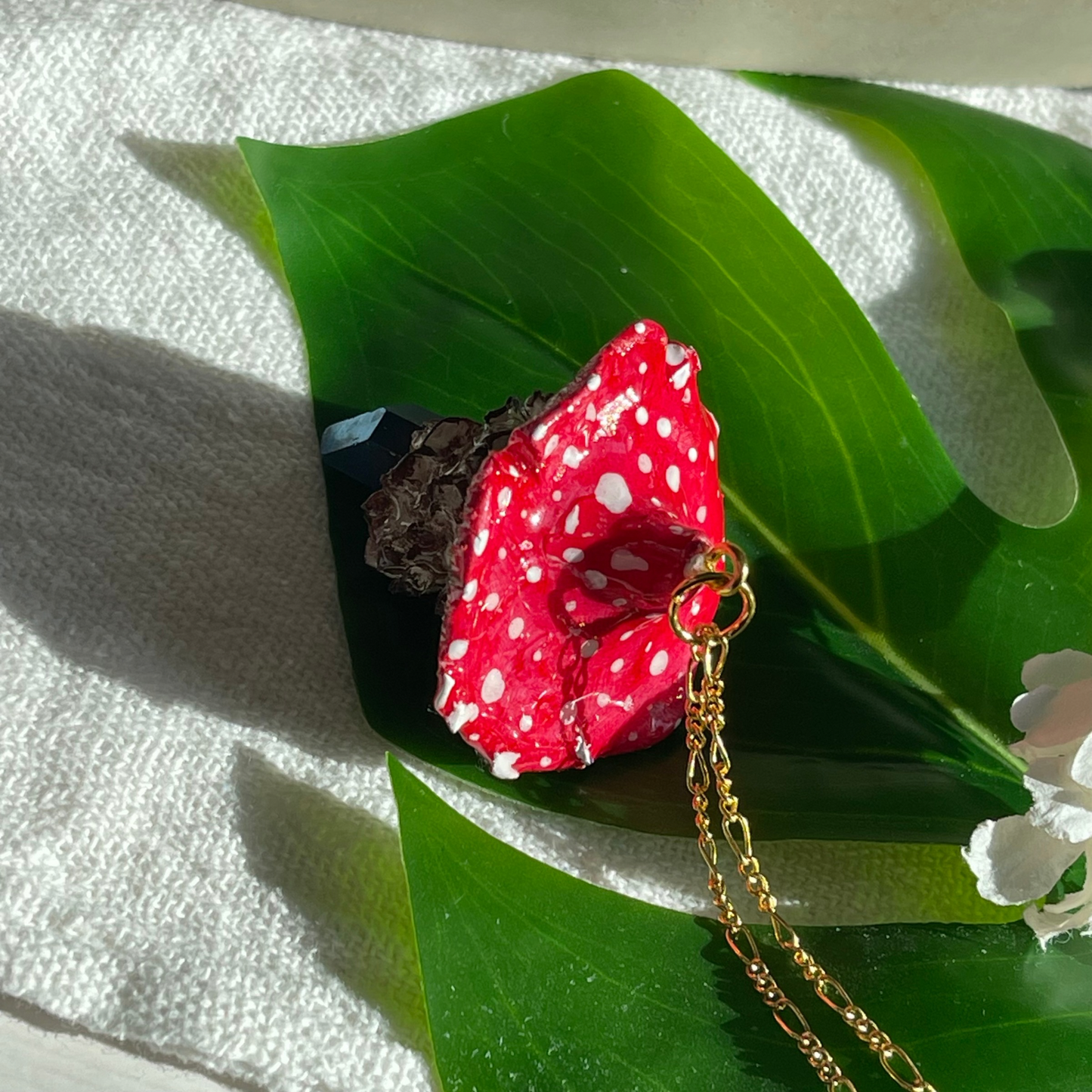 Handcrafted necklace featuring a blue quartz crystal and a polymer clay mushroom pendant, perfect for bohemian and nature-inspired fashion.