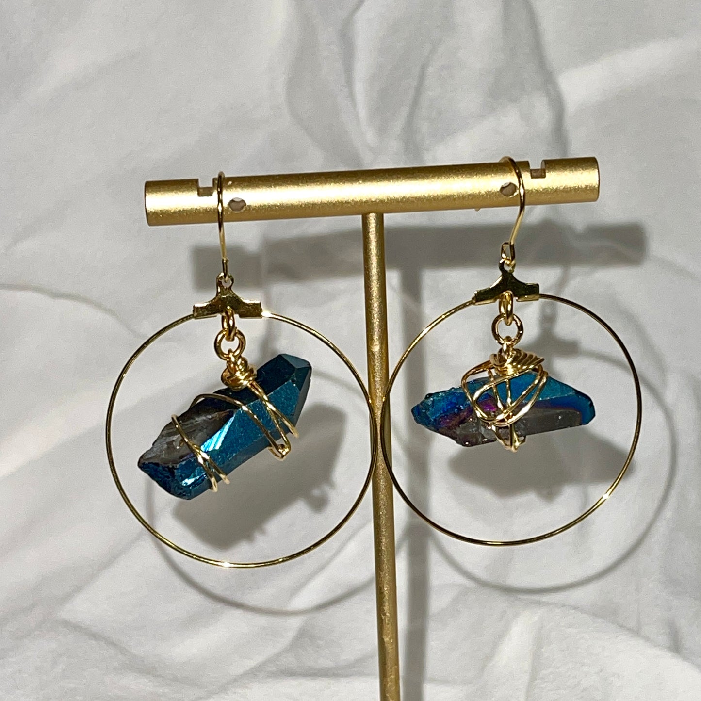 Stunning Quartz Hoop Earrings - Handcrafted from 18k gold-plated metal and radiant raw quartz coated in iridescent titanium, these lightweight earrings are perfect for wearing alone or layering. Known as the master healer, clear quartz amplifies energy and promotes clarity.