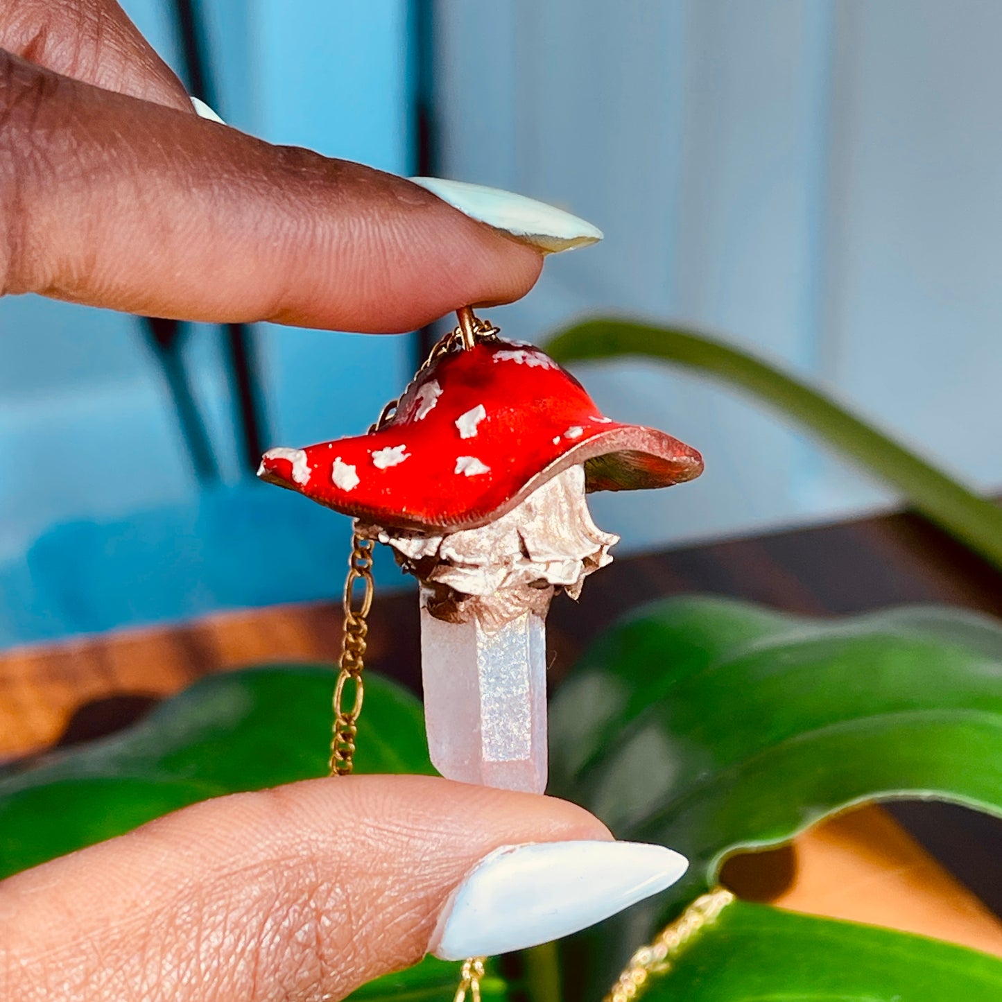 Handcrafted Toadstool Mushroom Necklace made from polymer clay with a shimmering quartz crystal, showcasing unique artistry and whimsical design, perfect for adding a magical touch to any outfit.