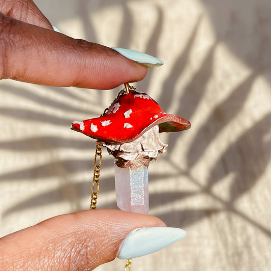 Handcrafted Toadstool Mushroom Necklace made from polymer clay with a shimmering quartz crystal, showcasing unique artistry and whimsical design, perfect for adding a magical touch to any outfit.