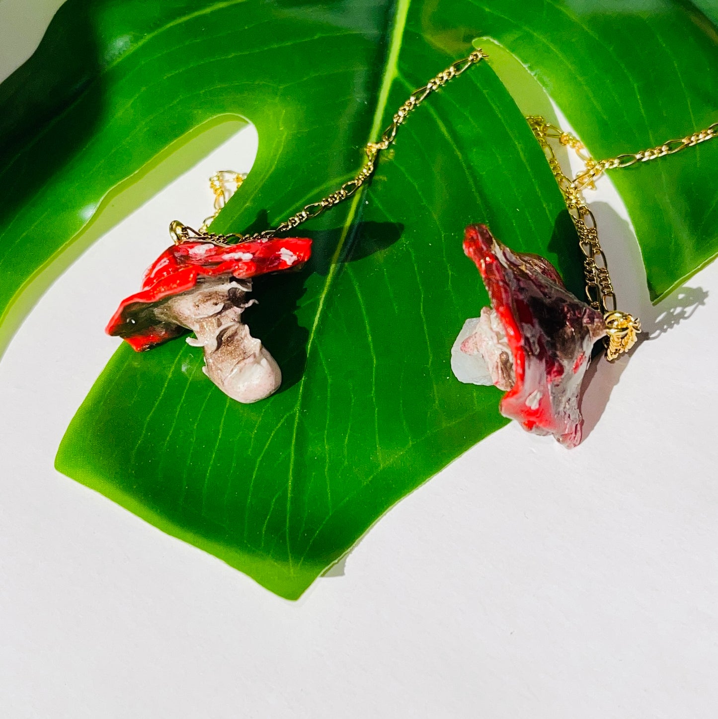 Handcrafted Toadstool Mushroom Necklace made from polymer clay with a shimmering quartz crystal, showcasing unique artistry and whimsical design, perfect for adding a magical touch to any outfit.