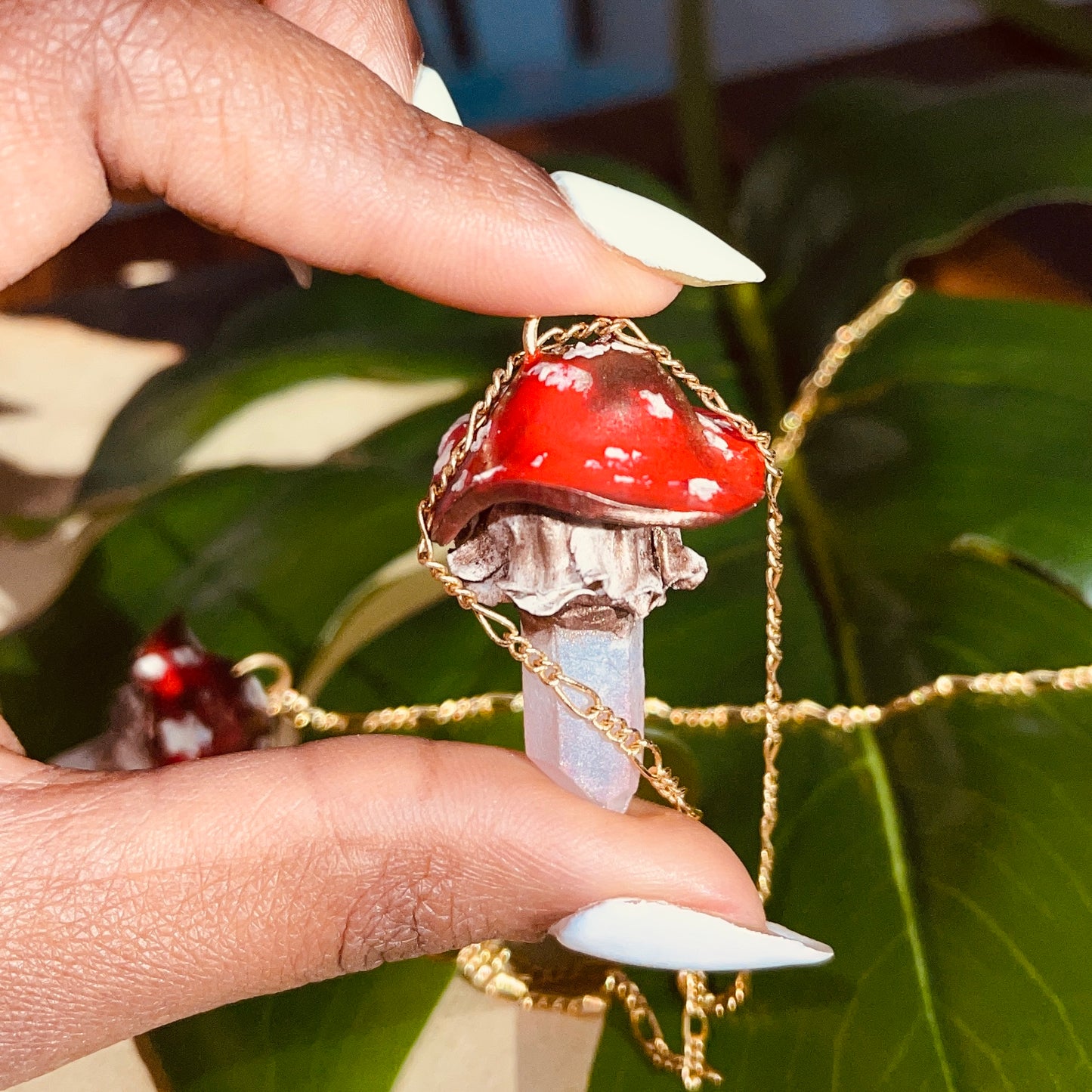 Handcrafted Toadstool Mushroom Necklace made from polymer clay with a shimmering quartz crystal, showcasing unique artistry and whimsical design, perfect for adding a magical touch to any outfit.
