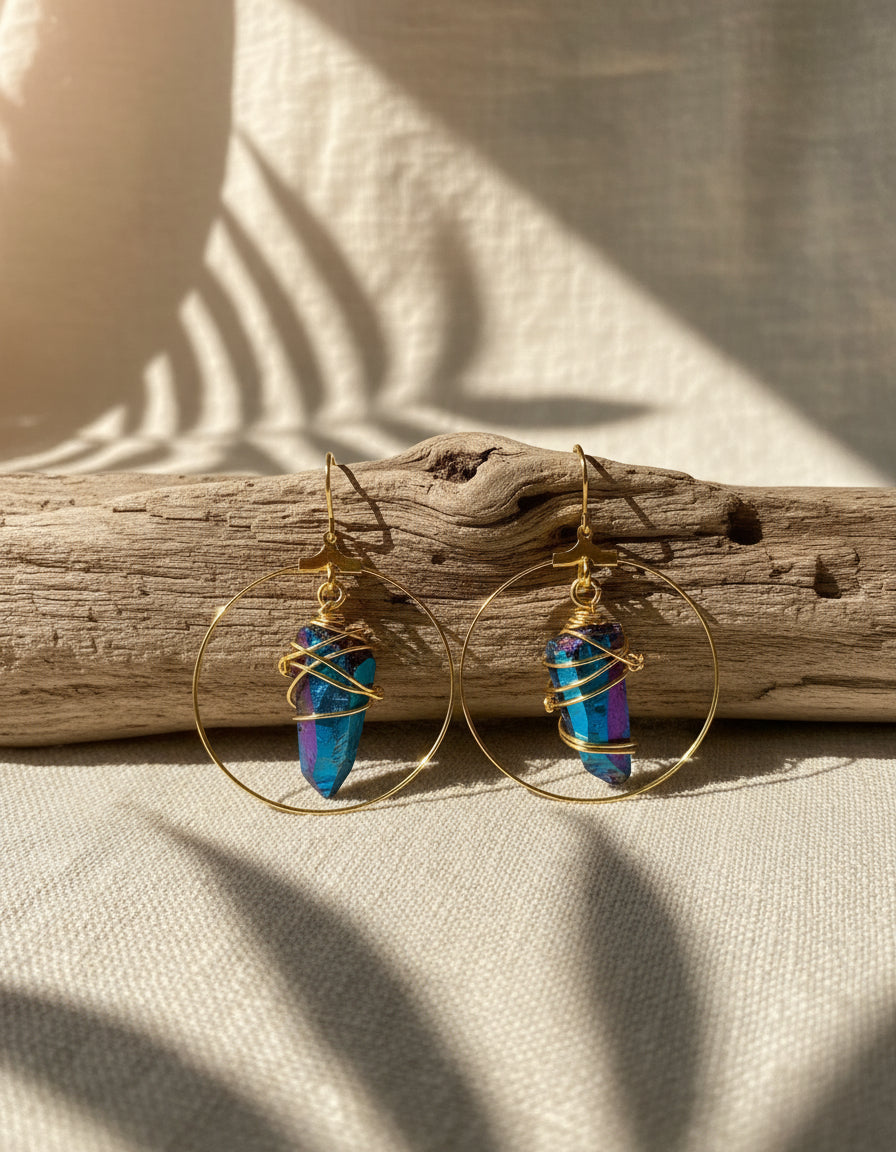 Stunning Quartz Hoop Earrings - Handcrafted from 18k gold-plated metal and radiant raw quartz coated in iridescent titanium, these lightweight earrings are perfect for wearing alone or layering. Known as the master healer, clear quartz amplifies energy and promotes clarity.