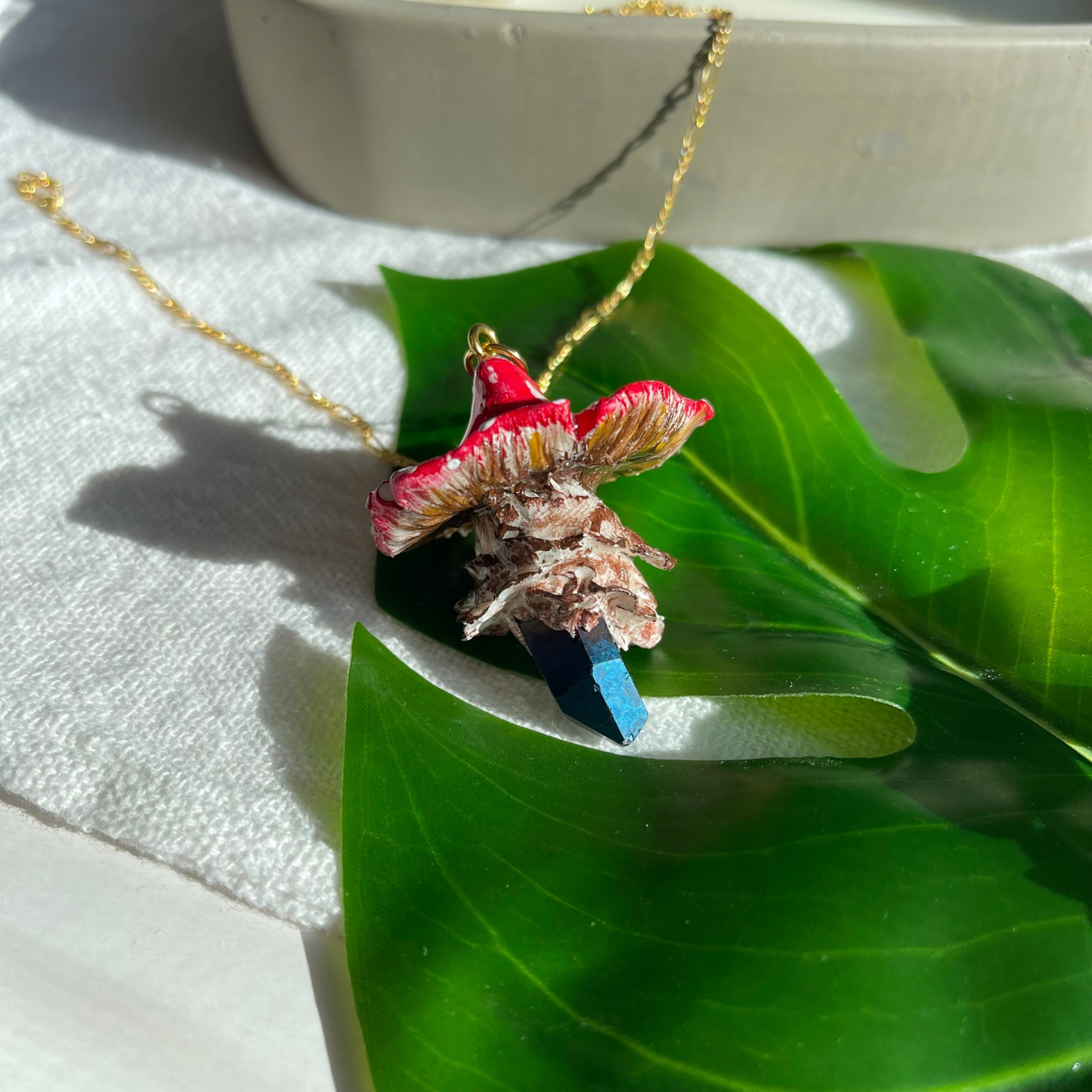 Handcrafted necklace featuring a blue quartz crystal and a polymer clay mushroom pendant, perfect for bohemian and nature-inspired fashion.