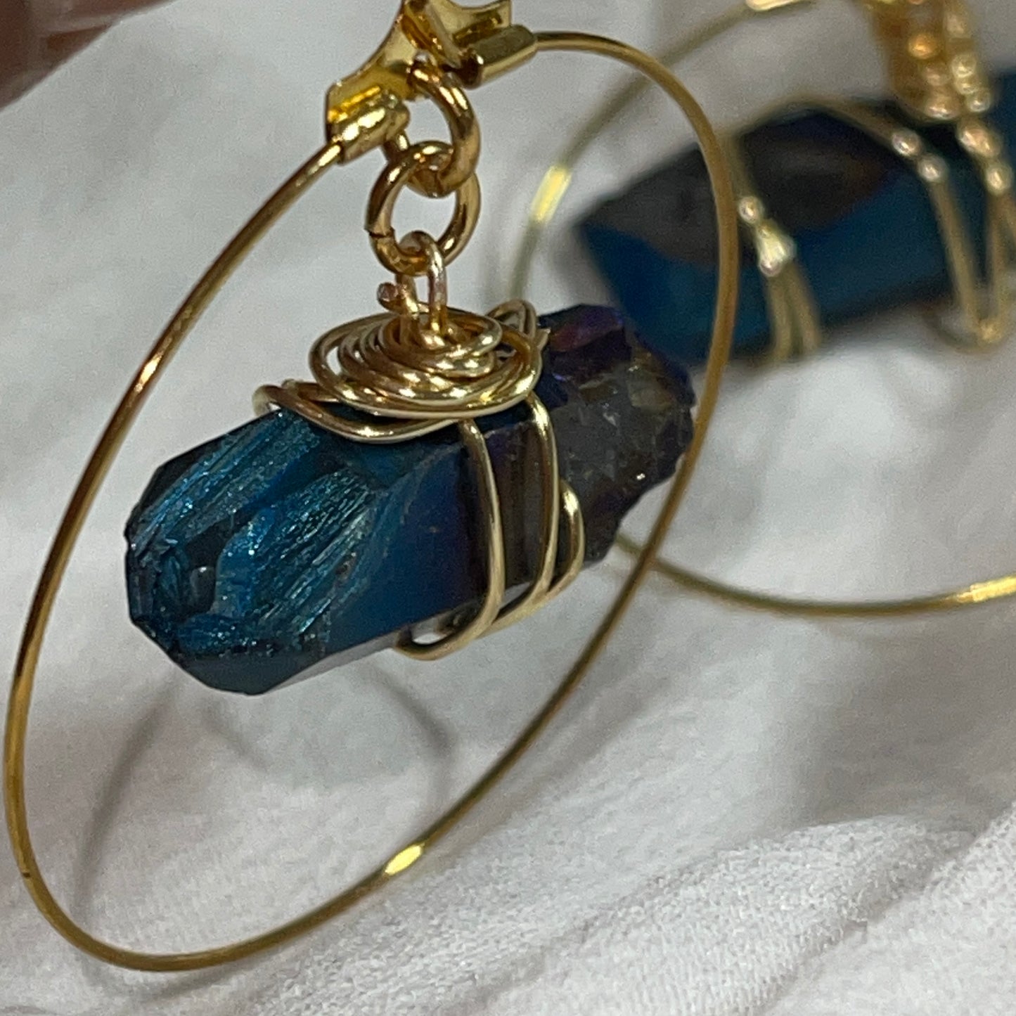 Stunning Quartz Hoop Earrings - Handcrafted from 18k gold-plated metal and radiant raw quartz coated in iridescent titanium, these lightweight earrings are perfect for wearing alone or layering. Known as the master healer, clear quartz amplifies energy and promotes clarity.