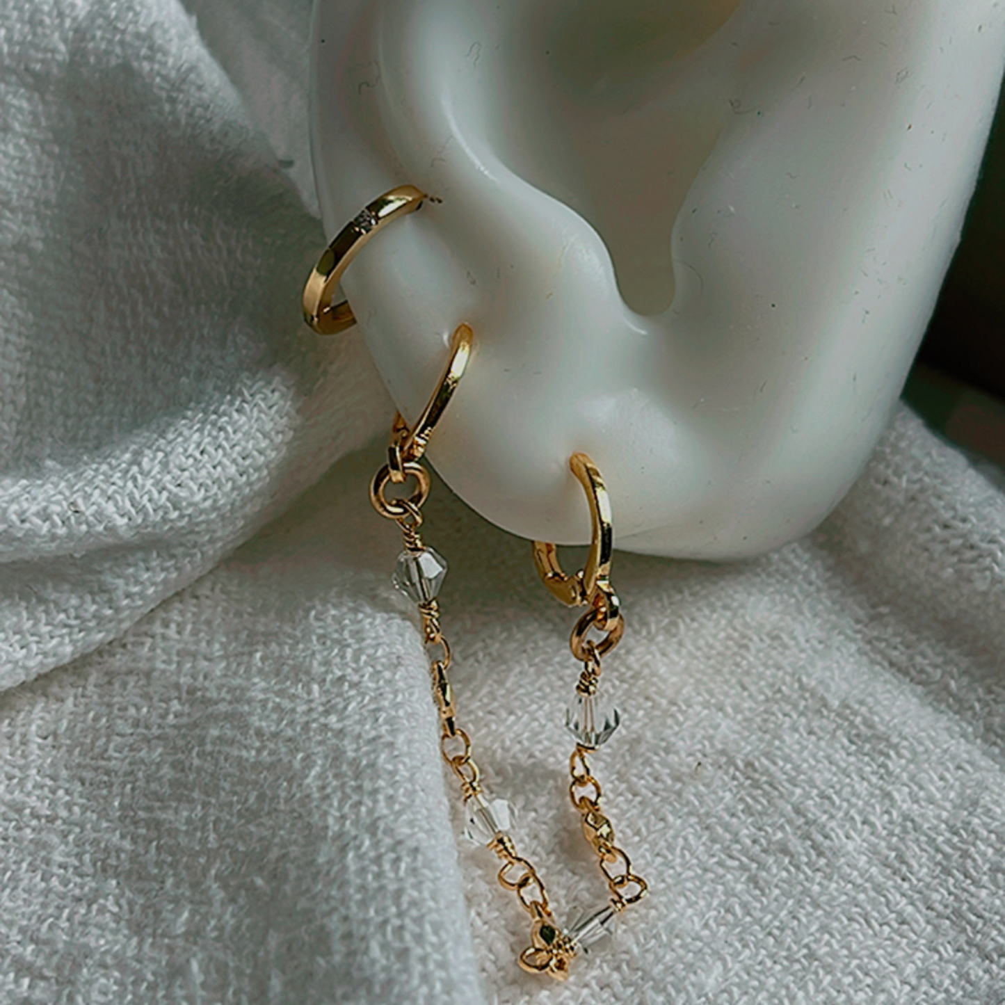 The Starlight Double Piercing Earring - a stunning and lightweight handmade accessory designed for everyday wear. This elegant earring is waterproof and tarnish-resistant, making it a perfect choice for upgrading your style. Ideal for those with double piercings.
