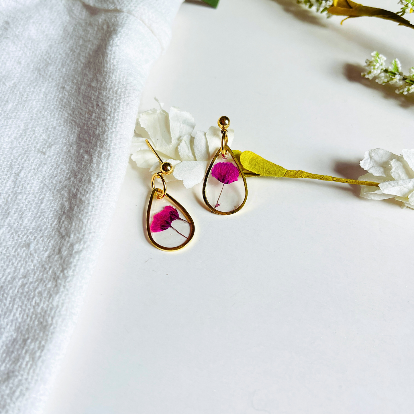 These Pink Petal Drop Earrings are handcrafted using real dried flowers, delicately preserved in resin for lasting beauty.