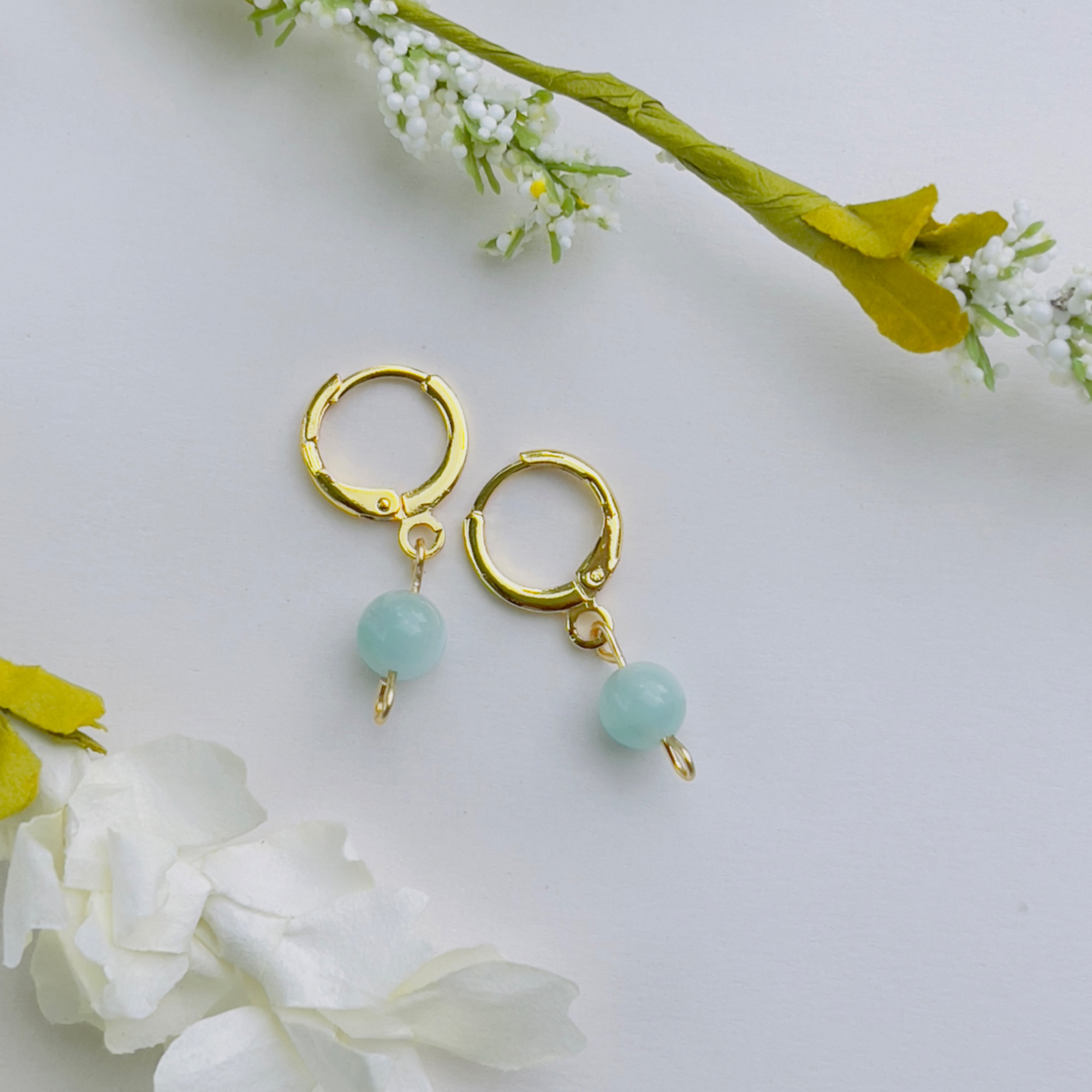 Handcrafted Green Moonstone Huggie Earrings made from 18K gold-filled stainless steel, featuring a delicate green moonstone linked to the Third Eye Chakra, enhancing intuition and spiritual growth. Lightweight and minimalistic design, perfect for everyday wear.