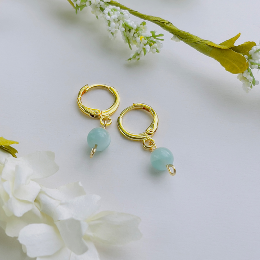 Handcrafted Green Moonstone Huggie Earrings made from 18K gold-filled stainless steel, featuring a delicate green moonstone linked to the Third Eye Chakra, enhancing intuition and spiritual growth. Lightweight and minimalistic design, perfect for everyday wear.
