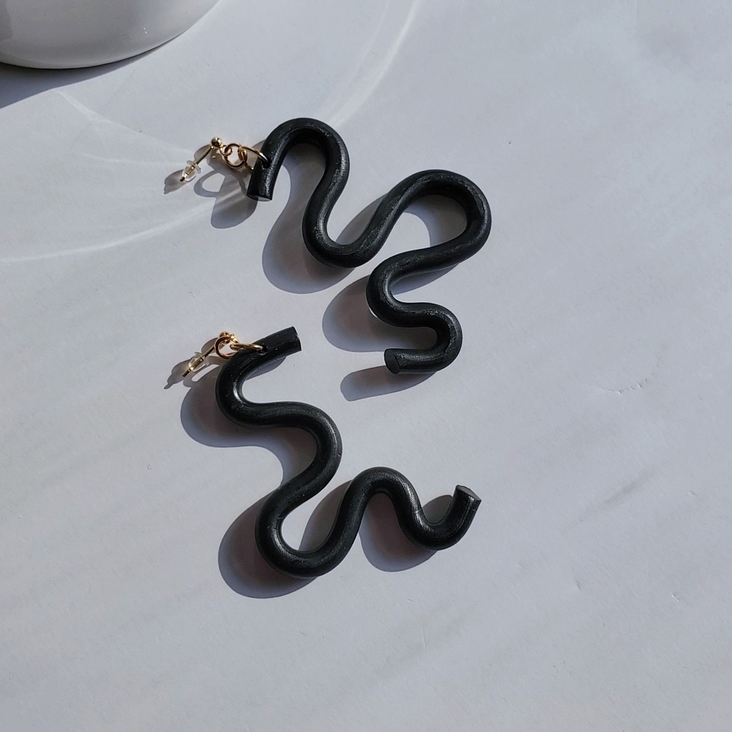 Handmade SELENE Swiggle Earrings crafted from polymer clay, featuring intricate artwork and modern geometric designs, lightweight and waterproof for a bold and unique accessory statement.