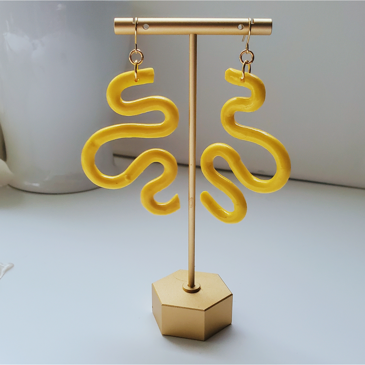 Handmade SELENE Swiggle Earrings crafted from polymer clay, featuring intricate artwork and modern geometric designs, lightweight and waterproof for a bold and unique accessory statement.