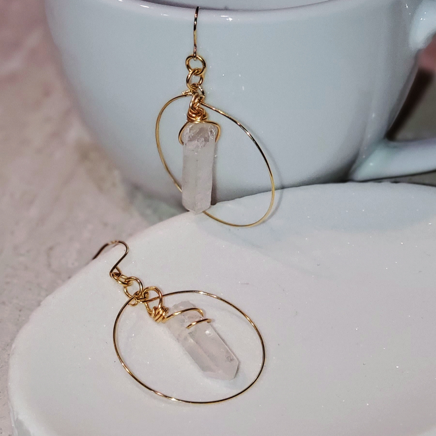 Handcrafted Minimalist Quartz Hoop Earrings featuring radiant raw quartz crystals set in 18k gold-plated metal. Lightweight and versatile, perfect for statement or layered looks.