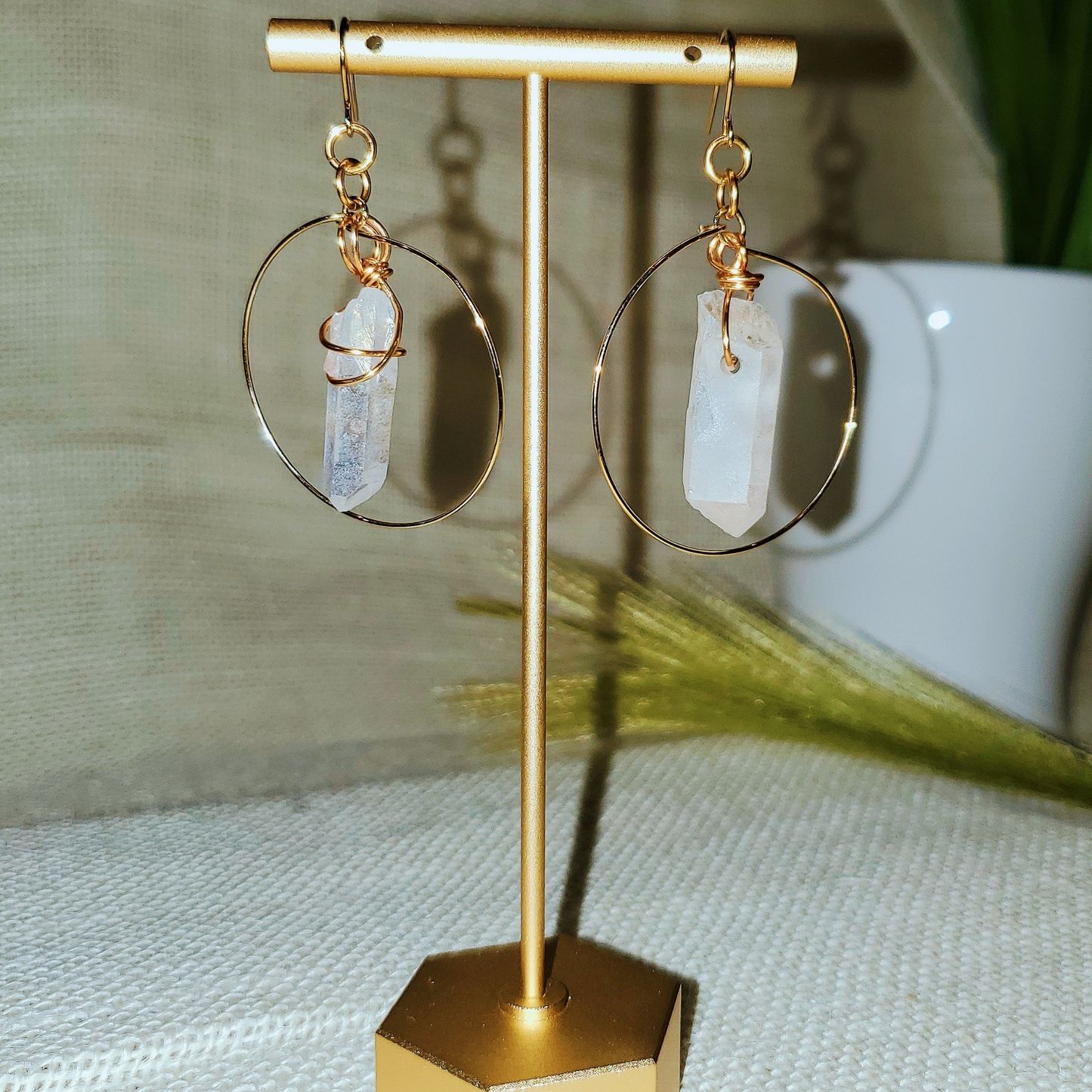Handcrafted Minimalist Quartz Hoop Earrings featuring radiant raw quartz crystals set in 18k gold-plated metal. Lightweight and versatile, perfect for statement or layered looks.