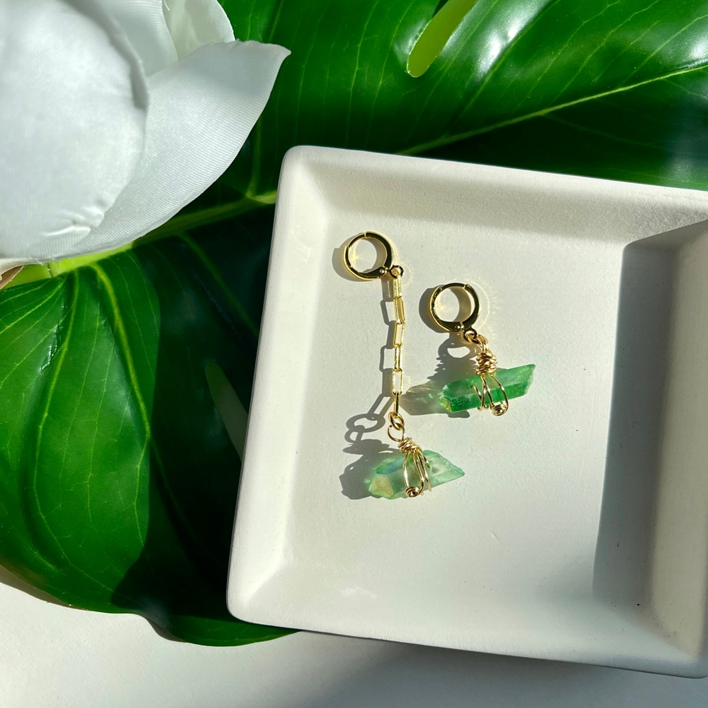 Handcrafted Aria Asymmetric Dangle Earring featuring a captivating Green Quartz crystal. Lightweight and lead/nickel-free, this unique piece adds elegance and boldness to any style.