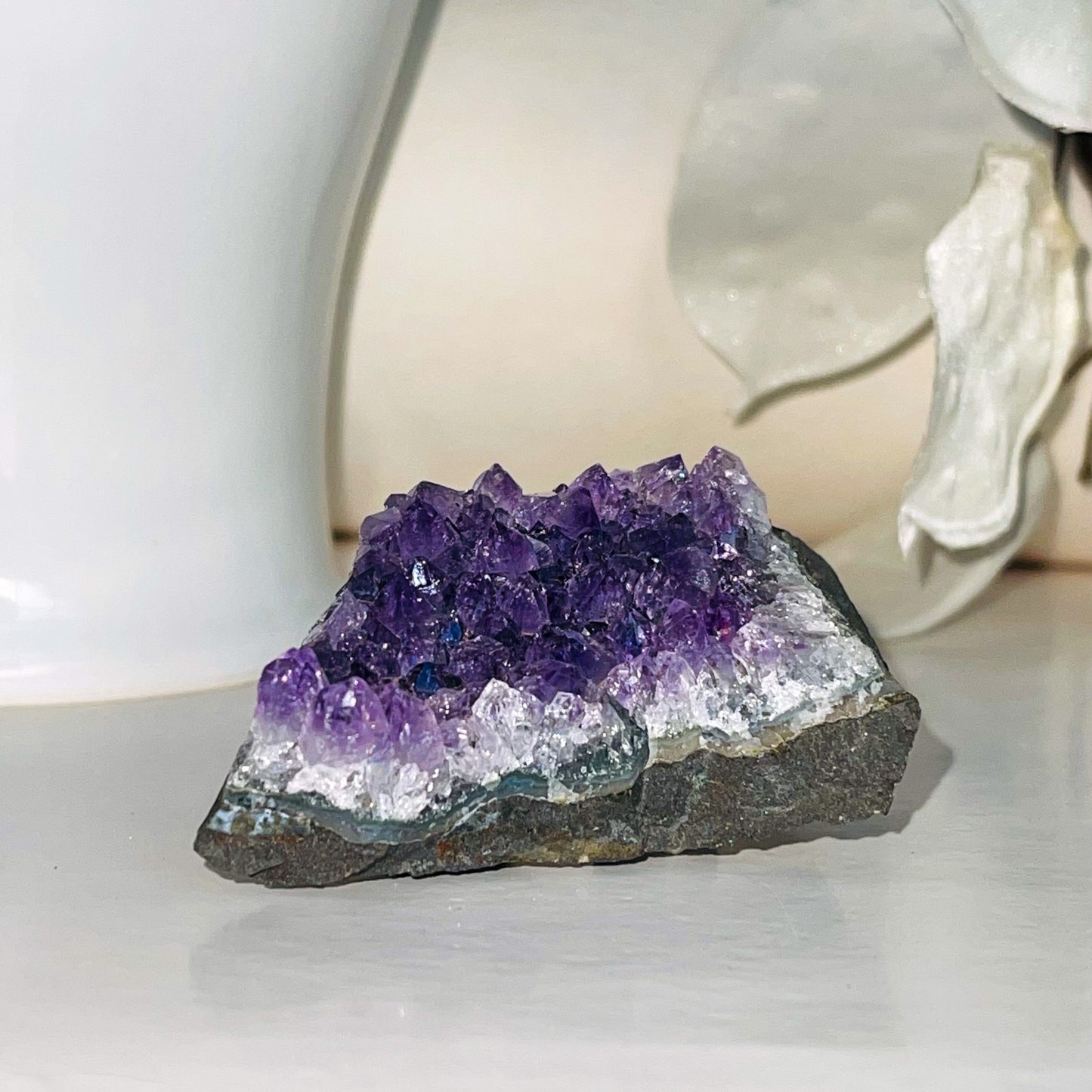 Close-up of a natural Amethyst crystal cluster showcasing deep purple hues and sparkling facets.