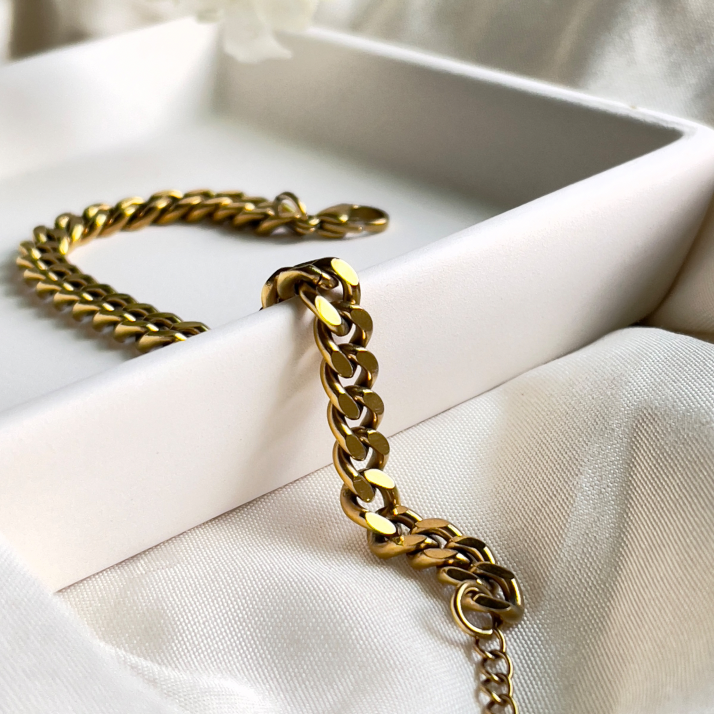 Alt text: Julia Cuban Bracelet - a luxurious 18k gold-plated accessory featuring a sleek 6mm width. Designed with hypoallergenic and waterproof materials for lasting comfort, it offers an adjustable fit suitable for any wrist size. Perfect for adding a touch of elegance to both casual and formal outfits.