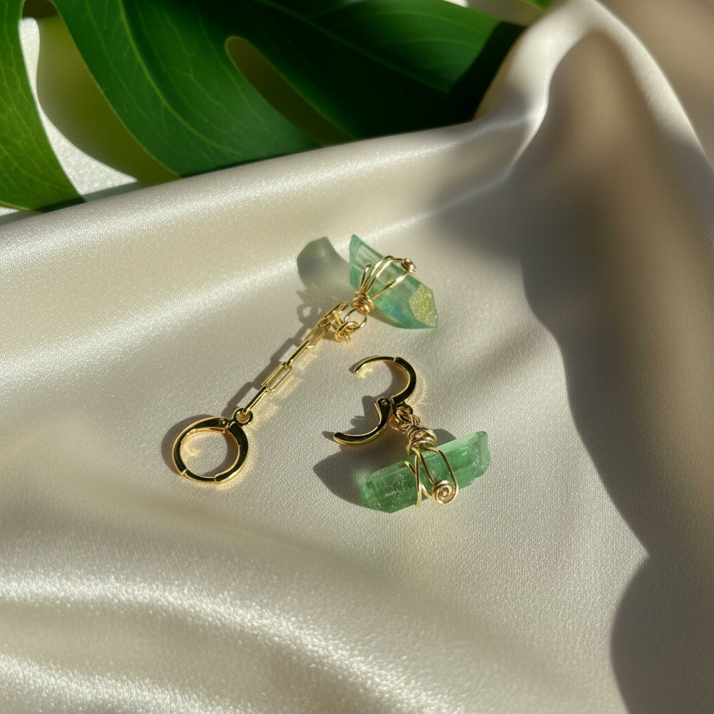 Handcrafted Aria Asymmetric Dangle Earring featuring a captivating Green Quartz crystal. Lightweight and lead/nickel-free, this unique piece adds elegance and boldness to any style.