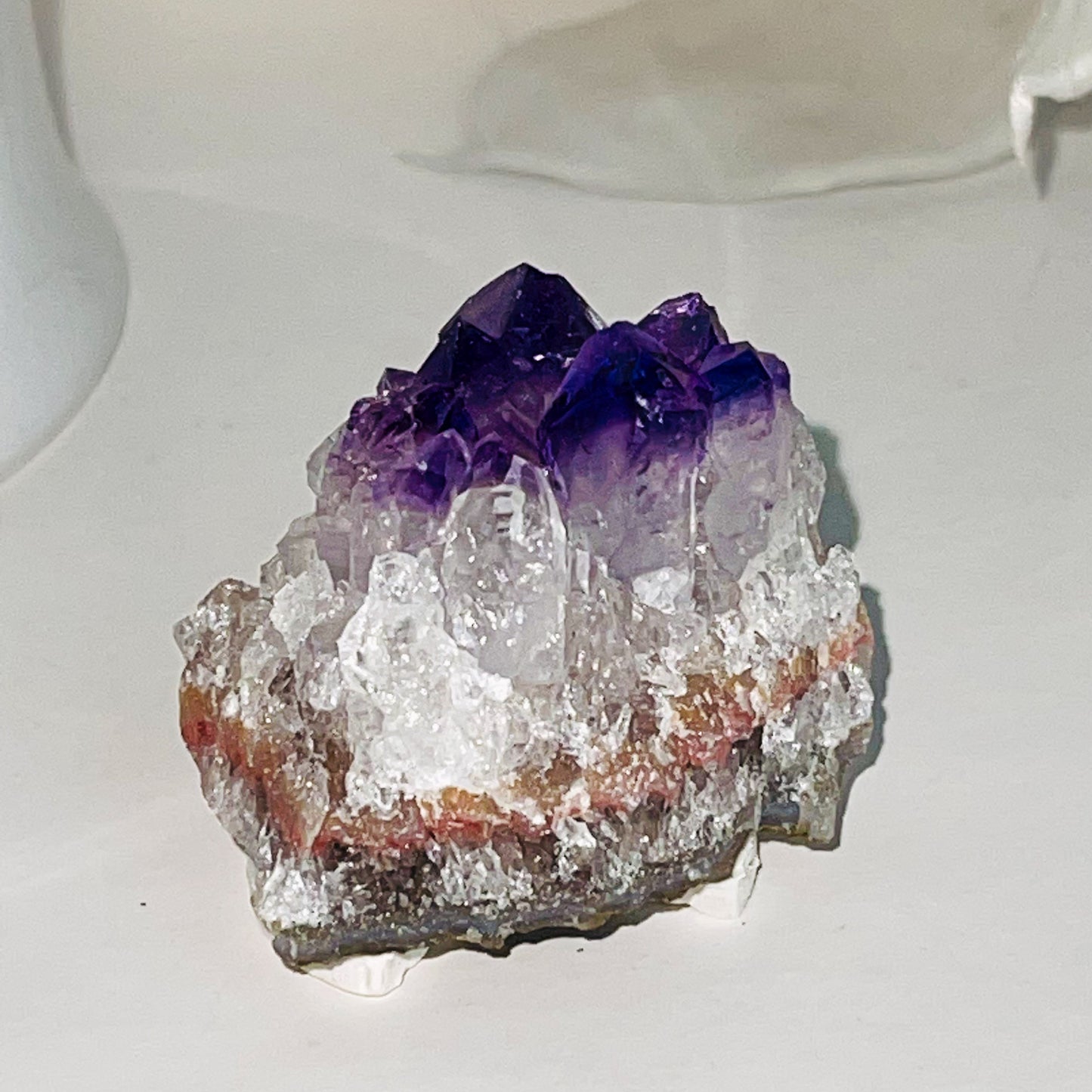 Close-up of a natural Amethyst crystal cluster showcasing deep purple hues and sparkling facets.