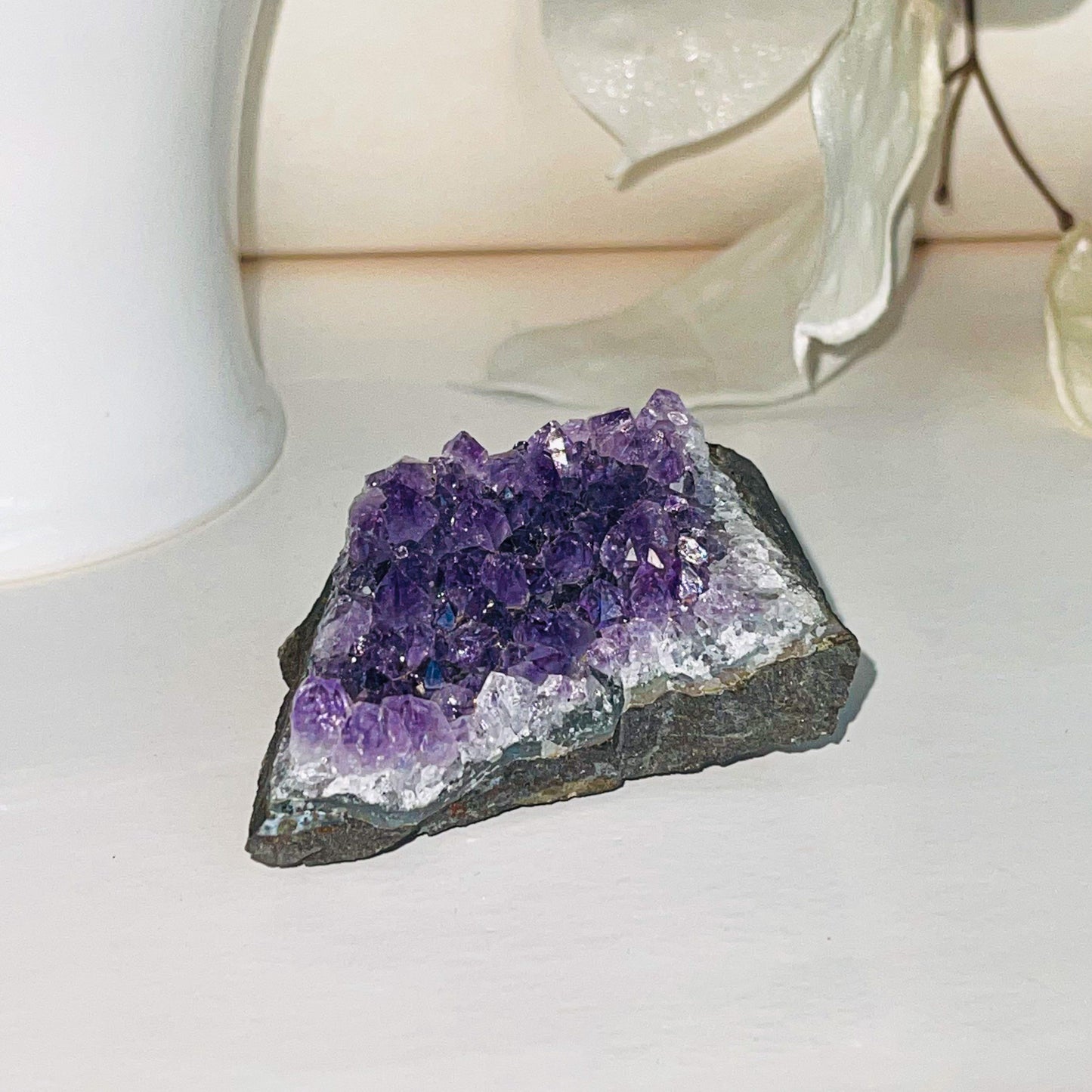 Raw Amethyst crystal point with vibrant purple color, perfect for meditation and spiritual healing practices.