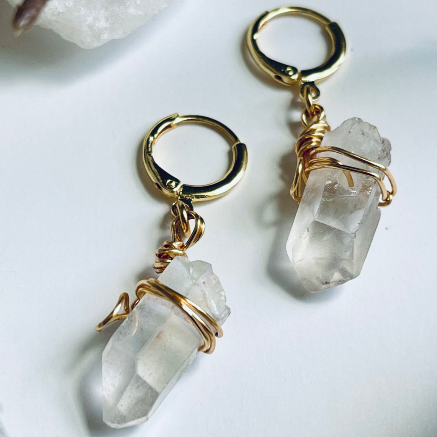 Handcrafted Mini Quartz Hoop Earring featuring a clear quartz gemstone delicately wrapped in 18k gold-plated wire, attached to a lightweight mini hoop. Perfect for layering or wearing alone, this unique piece embodies the properties of clarity and healing.