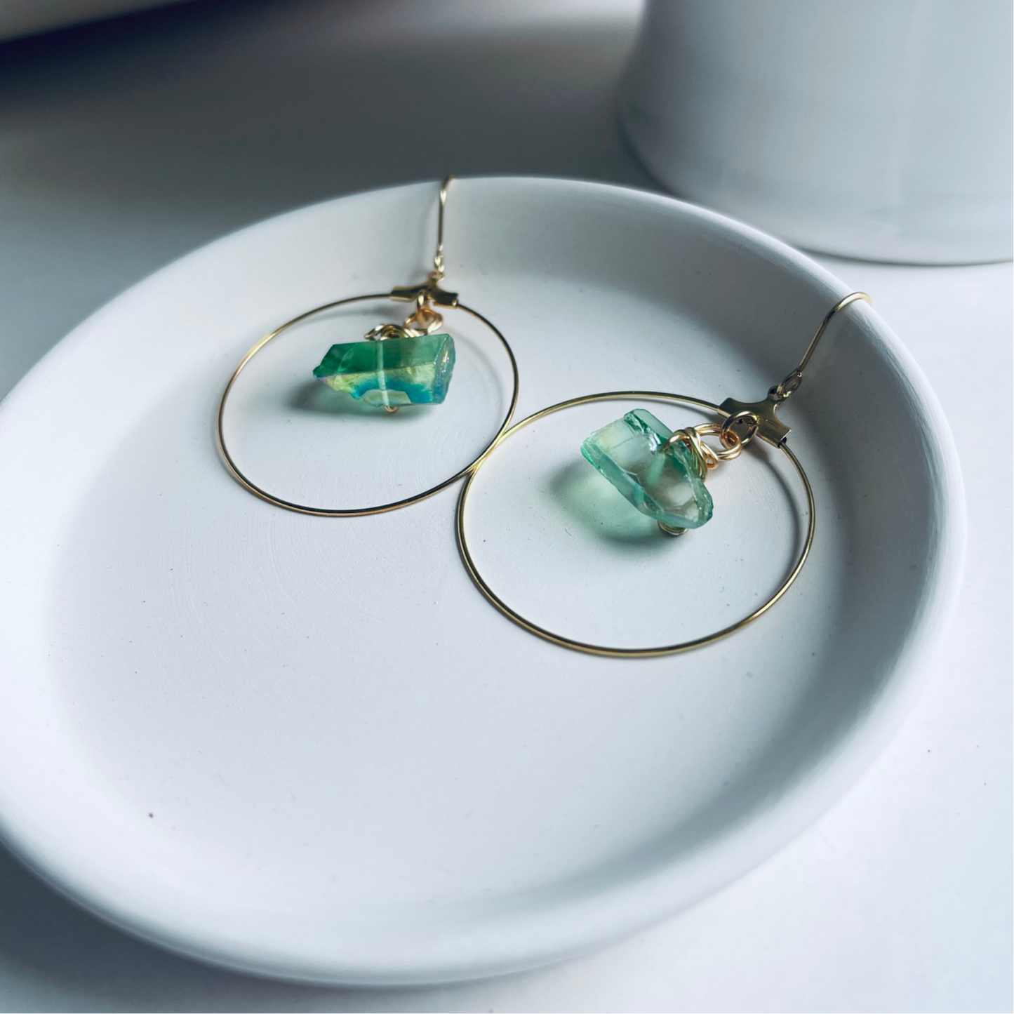 Handmade CORA Hoops featuring a wire-wrapped green quartz crystal and tarnish-resistant gold-filled ear wires, inspired by nature and the goddess of spring. Lightweight and lead/nickel-free, perfect for sensitive ears.