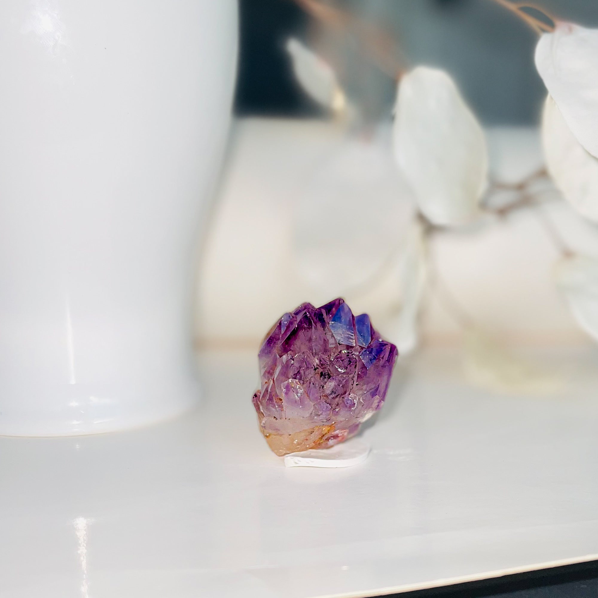Close-up of a natural Amethyst crystal cluster showcasing deep purple hues and sparkling facets.