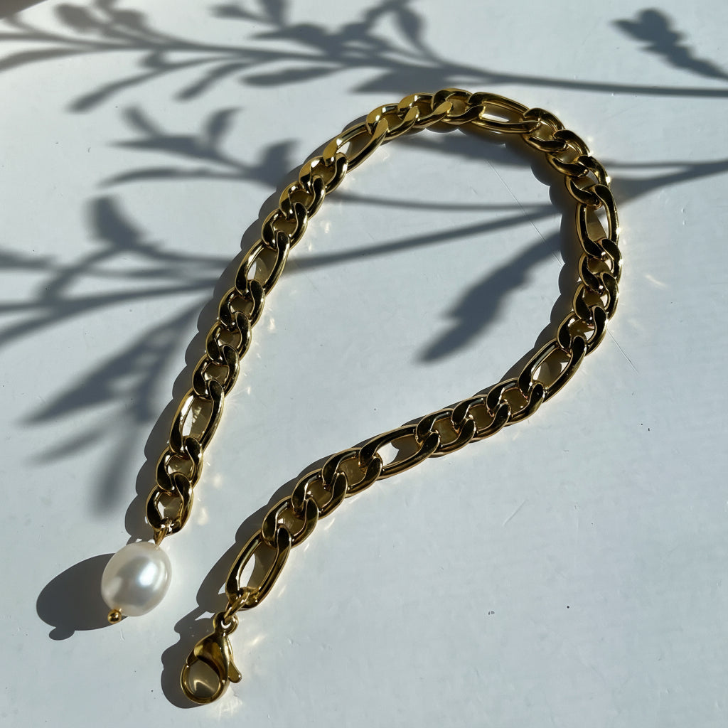 Exquisite 18k Gold Bracelet adorned with a single lustrous freshwater pearl, offering a blend of sophistication and elegance. Designed with hypoallergenic materials for skin comfort and featuring an adjustable fit, this bracelet is ideal for minimalist or layered styling, enhancing any outfit for everyday wear.