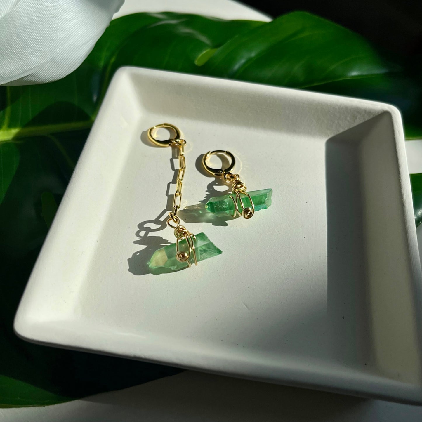 Handcrafted Aria Asymmetric Dangle Earring featuring a captivating Green Quartz crystal. Lightweight and lead/nickel-free, this unique piece adds elegance and boldness to any style.