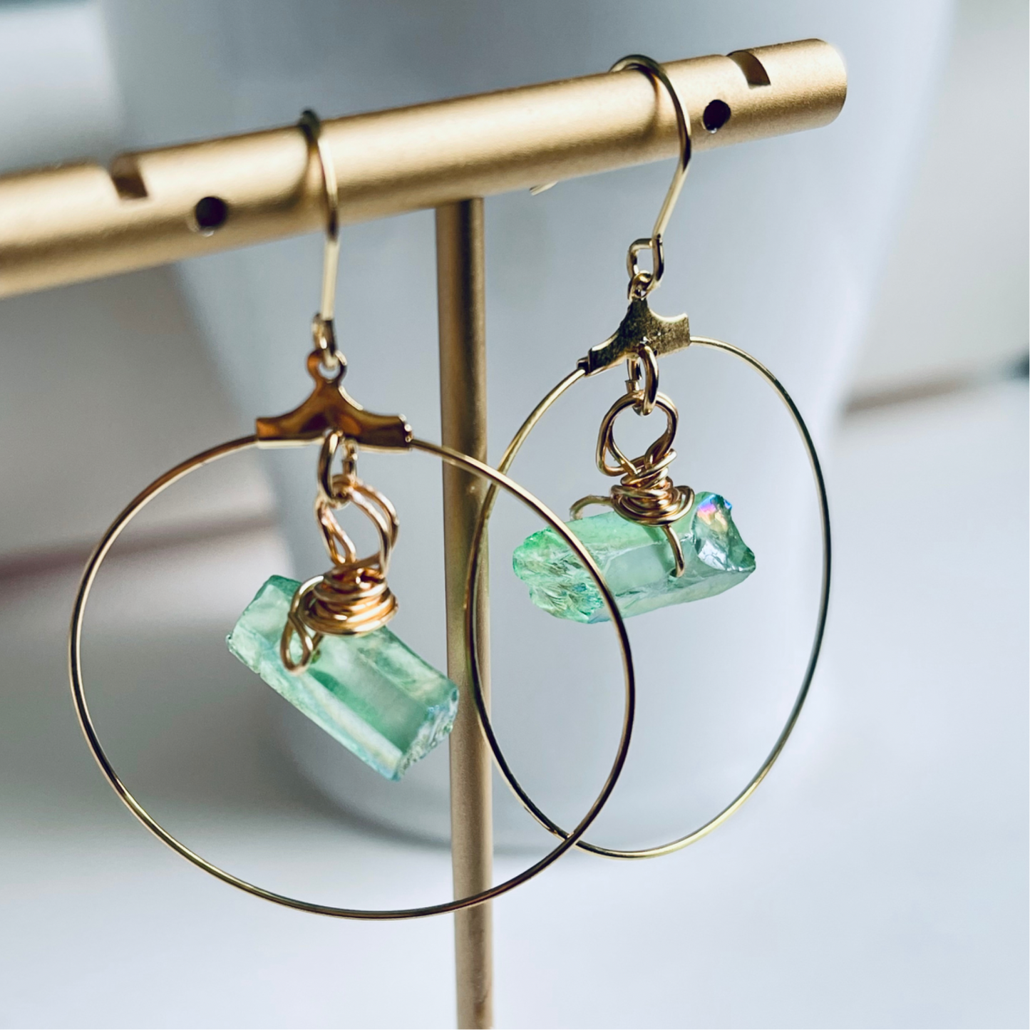 Handmade CORA Hoops featuring a wire-wrapped green quartz crystal and tarnish-resistant gold-filled ear wires, inspired by nature and the goddess of spring. Lightweight and lead/nickel-free, perfect for sensitive ears.