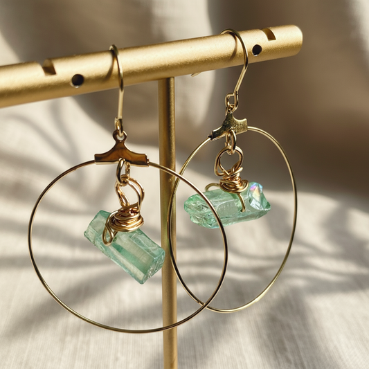 Handmade CORA Hoops featuring a wire-wrapped green quartz crystal and tarnish-resistant gold-filled ear wires, inspired by nature and the goddess of spring. Lightweight and lead/nickel-free, perfect for sensitive ears.