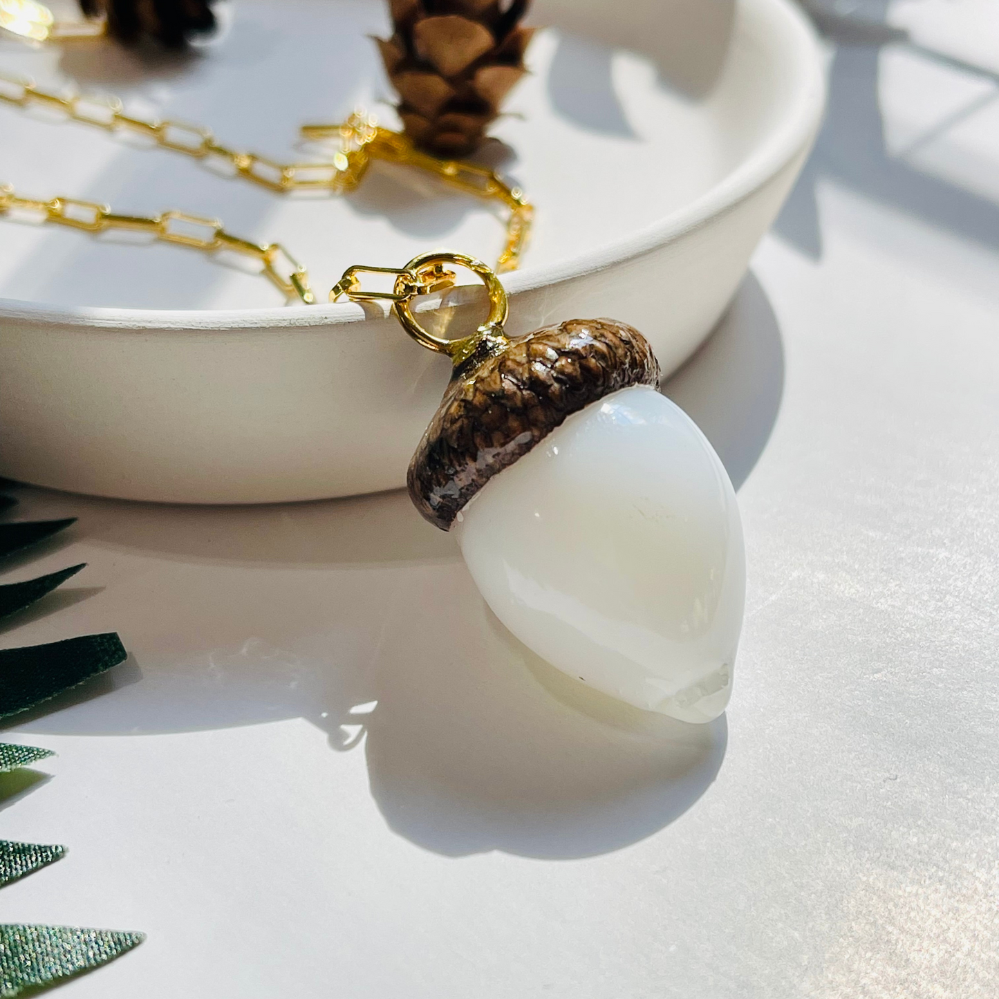 White acorn pendent gold necklace
